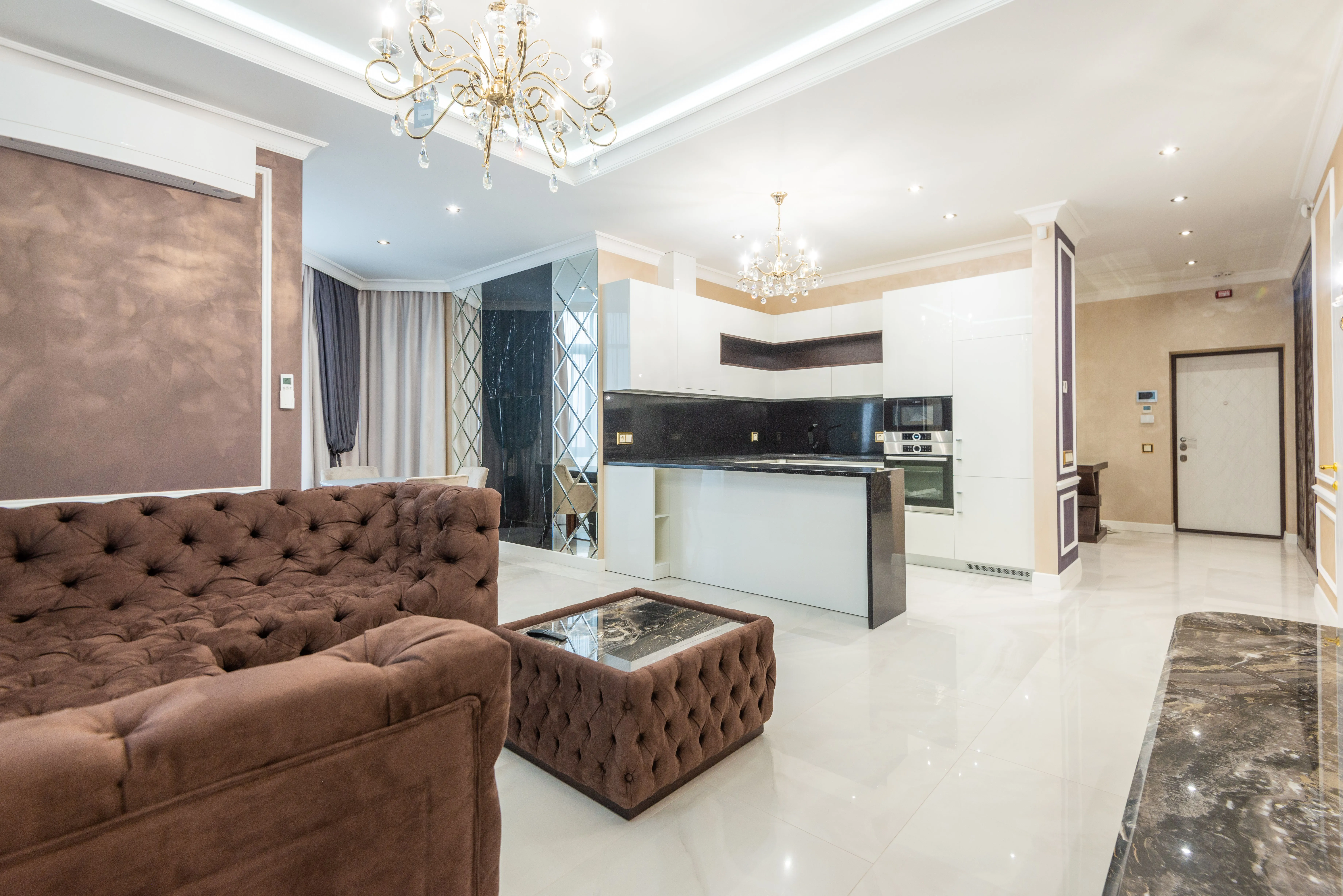 Luxurious open-plan living room with modern interior design and stylish lighting features.
