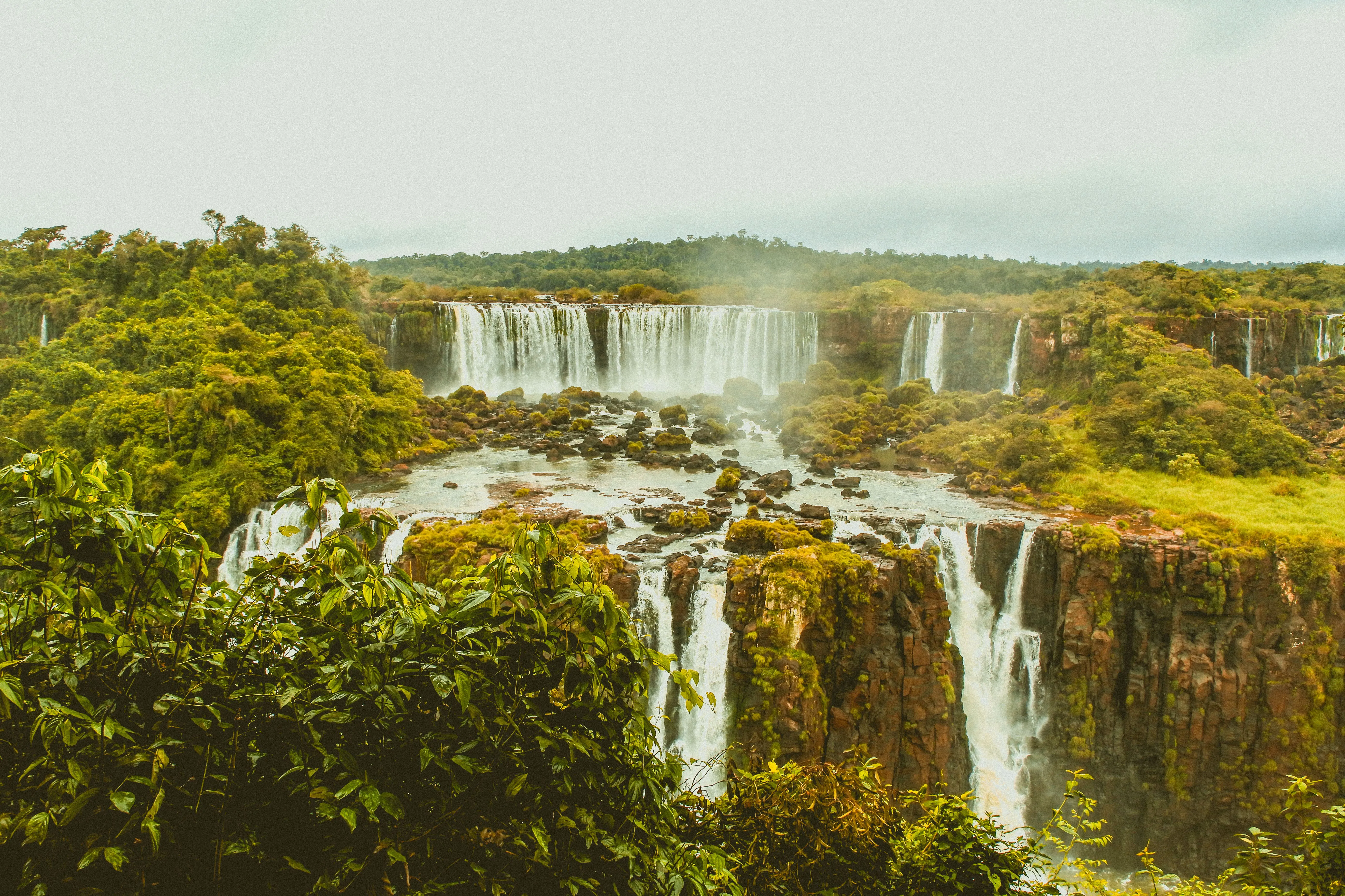 Beautiful panoramic view of the Iguazu Falls surrounded by lush greenery in Brazil.