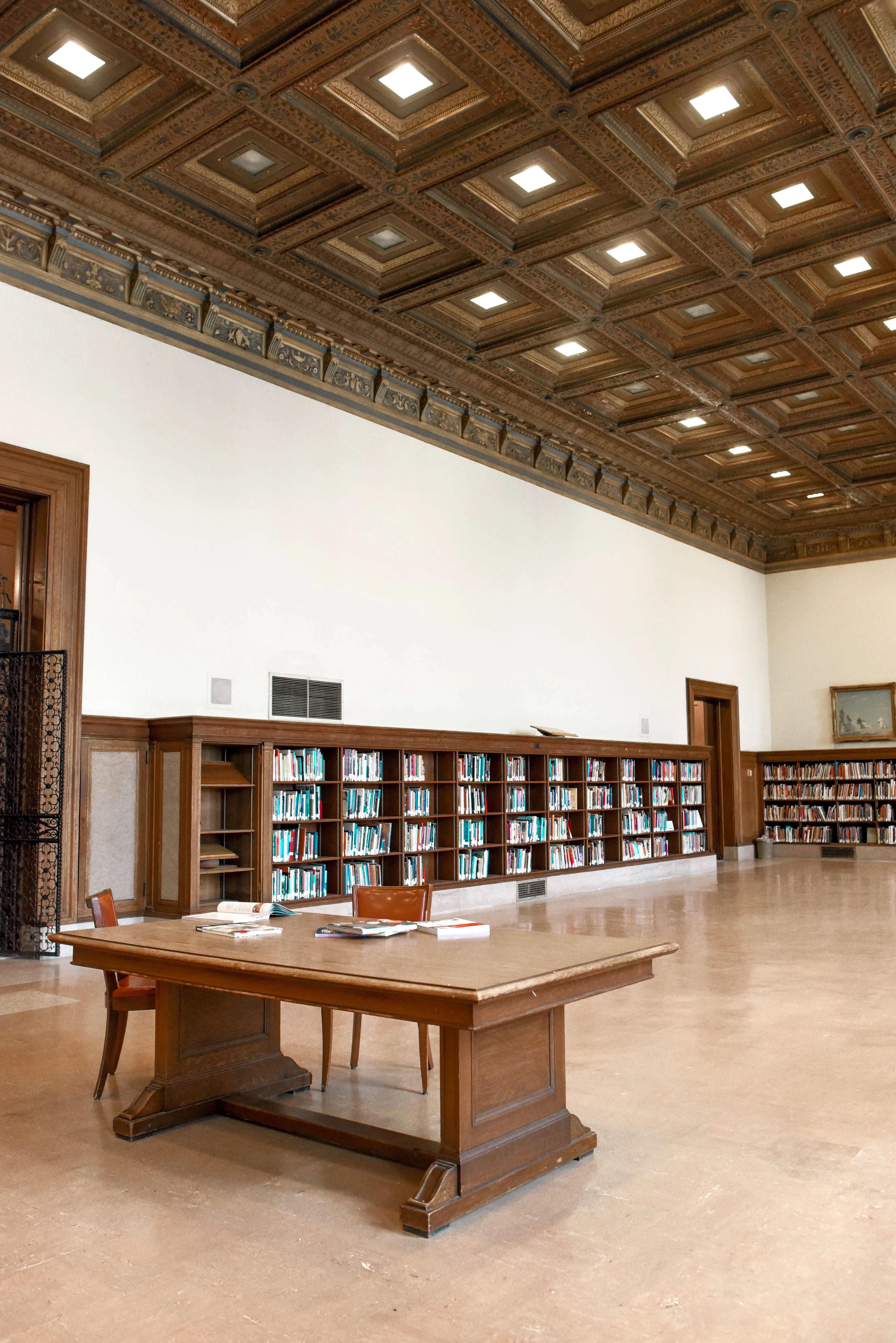 Elegant library interior with wooden shelves, books, and vintage design.