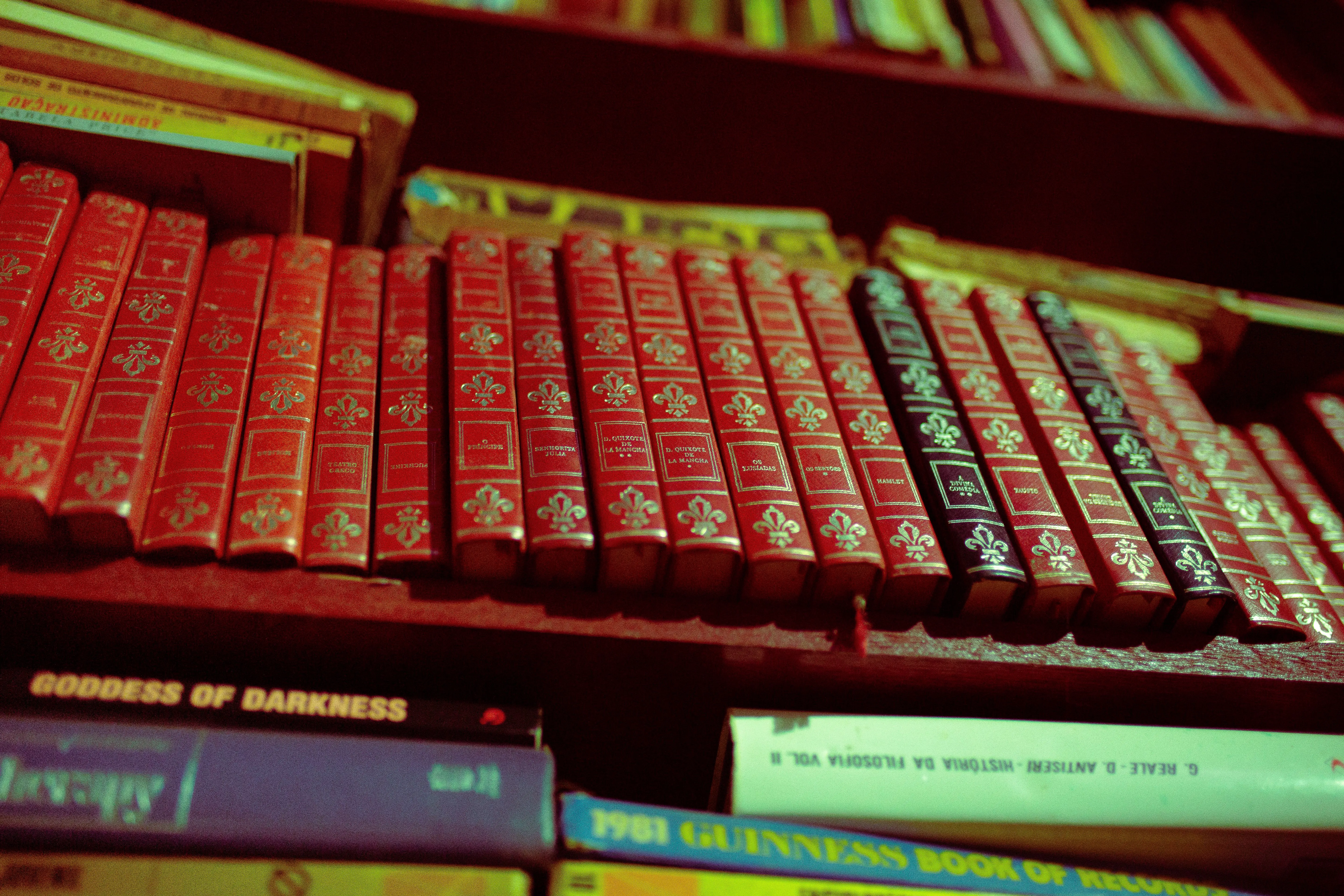 A close-up of a collection of vintage red books on a shelf, offering a classic literary vibe.