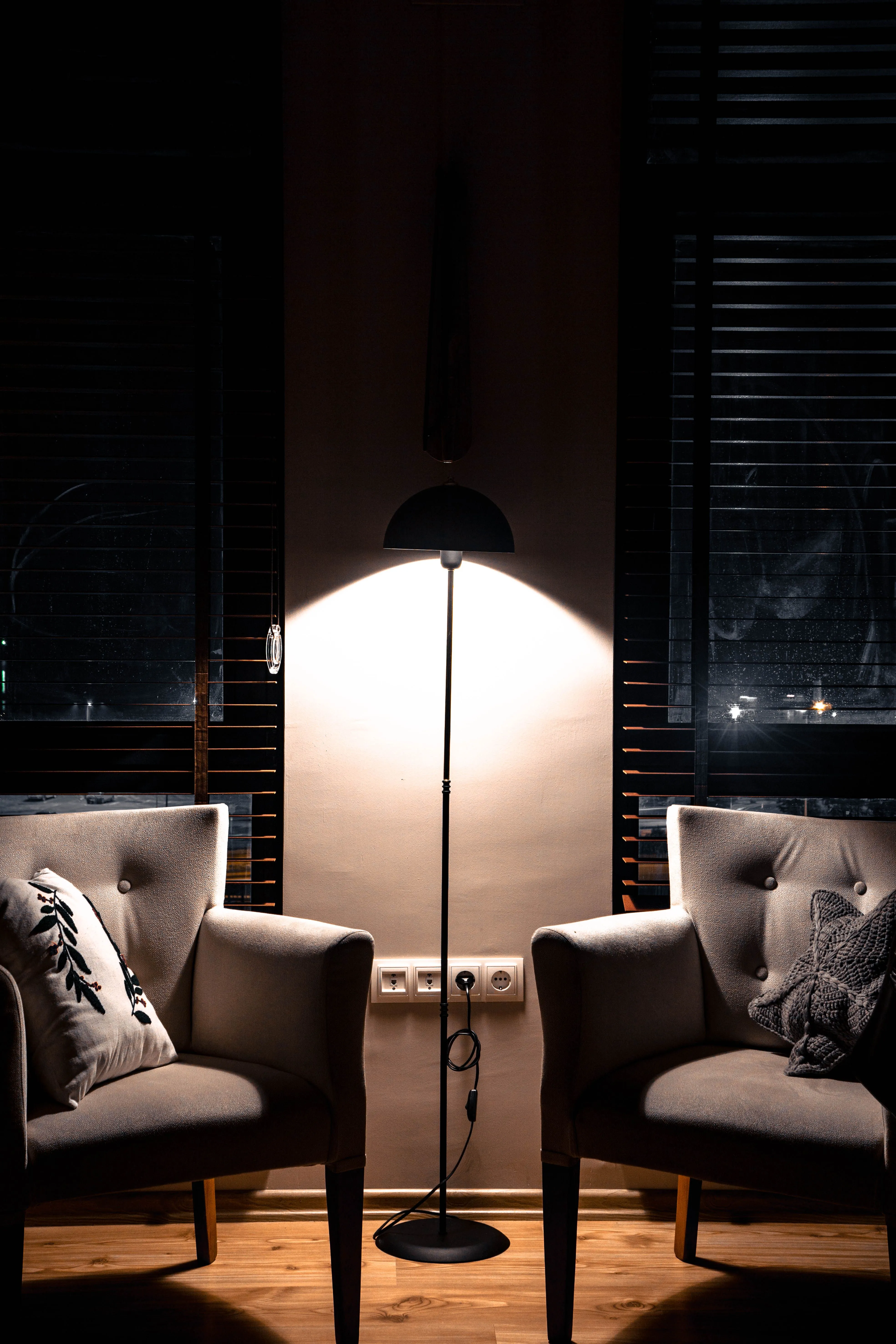 Elegant lounge with two armchairs and a floor lamp, perfect for cozy evenings.