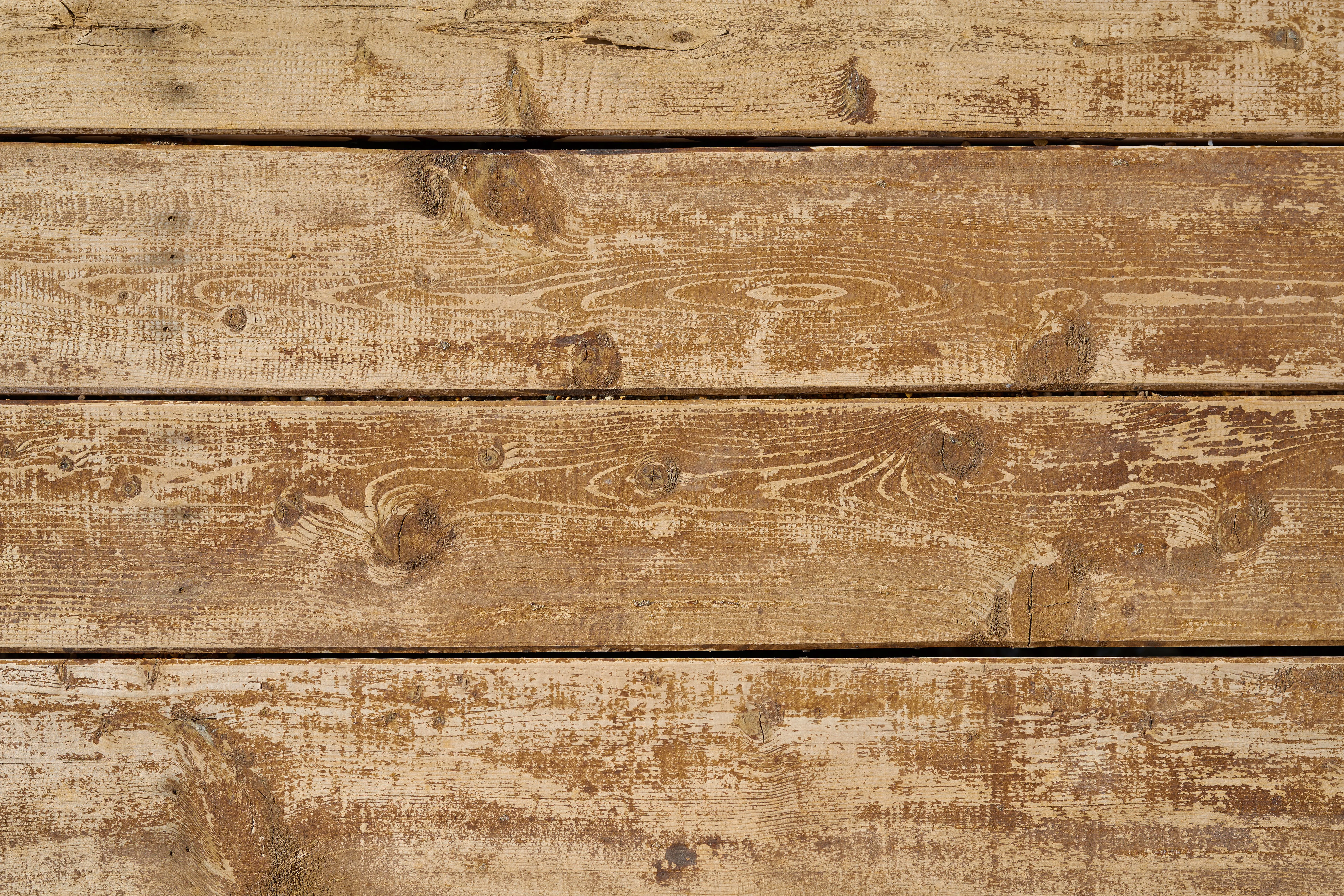 Weathered wooden planks with rustic grain texture, ideal for backgrounds.